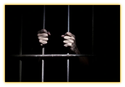 Man holding bars in prison cell