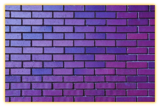 Purple Room Logo Purple Brick wall representing the Purple Room